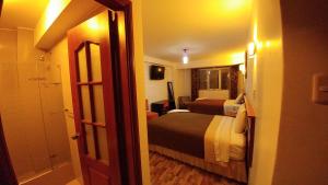 Postel nebo postele na pokoji v ubytování Libertad Hotel