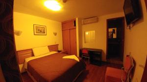 Postel nebo postele na pokoji v ubytování Libertad Hotel