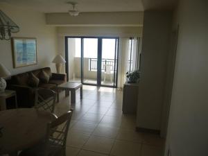 a living room with a couch and a table at Aquarius Beach Tower in Chalan Kanoa