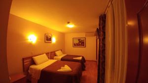 Postel nebo postele na pokoji v ubytování Libertad Hotel