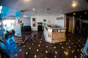 a living room with aoyer with stairs and a counter at Hotel Palace Frederico in Frederico Westphalen