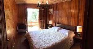 a bedroom with a white bed and a window at Casa Europa in Monte Verde