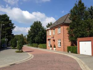 a red brick building with a white garage at Spacious Villa in Neerpelt near Welvaart Marina in Neerpelt