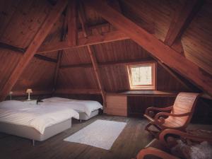 a attic room with two beds and a window at Spacious Villa in Neerpelt near Welvaart Marina in Neerpelt