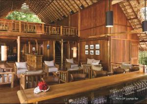 a large wooden building with chairs and a pool at The Barefoot At Havelock in Havelock Island +22 photos