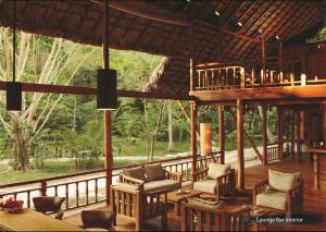 a porch of a house with chairs and a balcony at The Barefoot At Havelock in Havelock Island