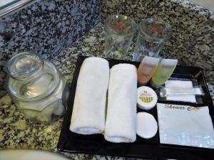 a tray with towels and other items on a counter at Hotel Grand Continental Kuching in Kuching