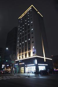 首爾的住宿－東大門金城大酒店，一座高大的建筑,晚上有标志
