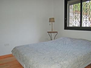 a bedroom with a bed and a window at Classy Apartment in La Turbie with Fenced Garden in La Turbie