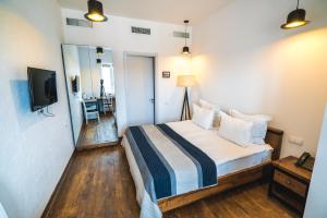 a hotel room with a bed and a television at Citadel Express in Tbilisi City