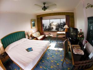 a living room with a couch and a television at Resorts World Kijal in Kijal