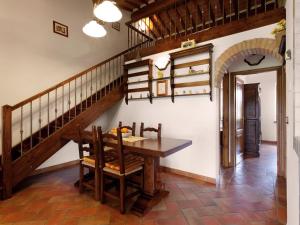 una sala da pranzo con tavolo e scala di Scenic Home in Foiano della Chiana with Terrace a Foiano della Chiana