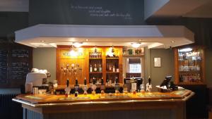 a bar in a restaurant with a counter at Station Hotel in Hucknall