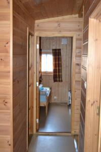 a small room with a room with a bed and a window at Egenes Camping in Flekkefjord +74 photos