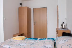 a bedroom with a bed and a closet and a cabinet at ŠD Urbánkova 2 in Košice