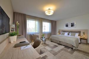 a hotel room with a bed and a desk and a room at Hotel Residenz Oberhausen in Oberhausen