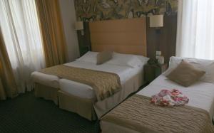 Posteľ alebo postele v izbe v ubytovaní LH Hotel Sirio Venice