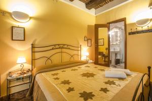 a bedroom with a large bed with yellow walls at B&B L'Alloggio Dei Vassalli in Naples