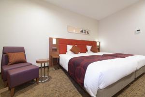 Postel nebo postele na pokoji v ubytování HOTEL MYSTAYS Haneda
