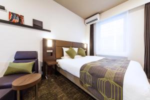 Postel nebo postele na pokoji v ubytování HOTEL MYSTAYS Haneda