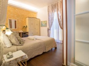 a small bedroom with a bed and a window at Hotel Marina in Monterosso al Mare