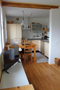 a kitchen with a table and a dining room at Lake View Holiday Home in Cerknica