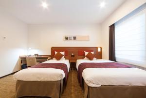 Postel nebo postele na pokoji v ubytování HOTEL MYSTAYS Haneda