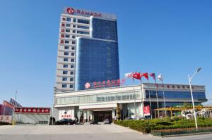 a large building with a sign on top of it at Ramada Linyi North in Linyi