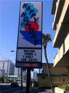 a sign on the side of a street at Happy Holiday Motel in Myrtle Beach