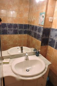 a bathroom with a white sink and a mirror at Les Jasmins in Collioure +41 photos