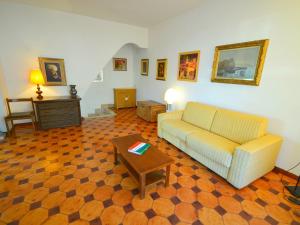 a living room with a couch and a coffee table at Modern Holiday Home in Massa with Garden in Marina di Massa