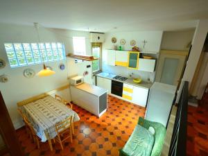 an overhead view of a kitchen with a table and chairs at Modern Holiday Home in Massa with Garden in Marina di Massa