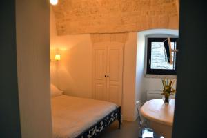 Postel nebo postele na pokoji v ubytování Terrazza Sui Trulli