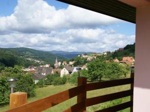 a view of a town from the balcony of a house at Comfortable Holiday Home with Fenced Garden in Natzwiller in Natzwiller