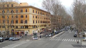 a busy city street with cars parked in front of buildings at Correa Vatican Hospitality in Rome