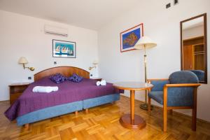 A bed or beds in a room at Apartments Kralj