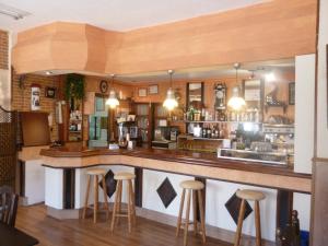 a bar in a restaurant with stools at Casa Hostal Olga - Castilla y León in Cofiñal