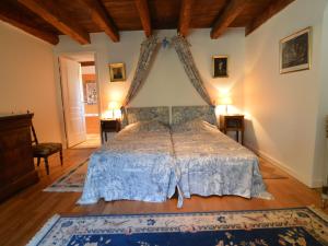 a bedroom with a bed in a room with wooden ceilings at Spacious Holiday Home in Ass rac with a Fenced Pond in Assérac