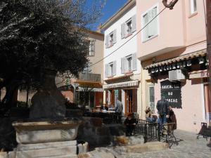 a street with a fountain in front of a building at Maison De Village in Saint-Raphaël
