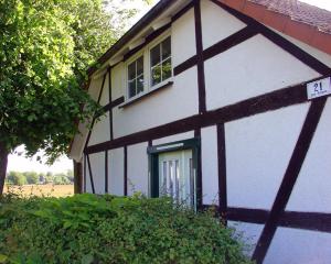 a white and black house with a window at Ferienhaus Helene in Michaelsdorf