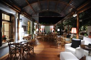 a restaurant with wooden floors and tables and chairs at Boutique Hotel Kentrikon & Bungalows in Agios Ioannis Pelio