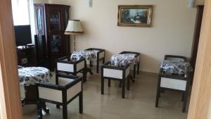 a room with four chairs and a picture on the wall at Family Pension in Arad