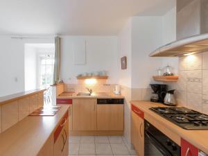 a kitchen with a sink and a stove top oven at Elegant Escape in Lanrelas in Lanrelas
