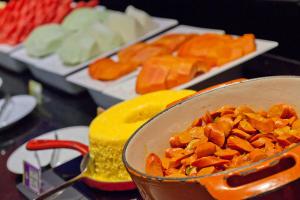 a bowl of food on a table with other foods at Go Inn Hotel Aracaju in Aracaju