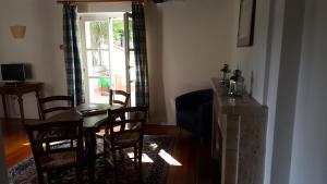 a dining room with a table and chairs and a window at Villa Di Tissano in Tissano