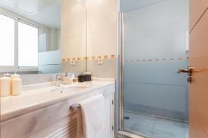a bathroom with a sink and a shower at Soho Lounge - Space Maison Apartments in Seville