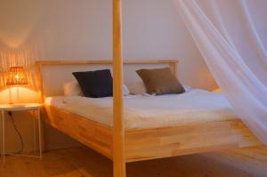 a bedroom with a wooden bunk bed with a lamp at Guest House Vasara in Nida