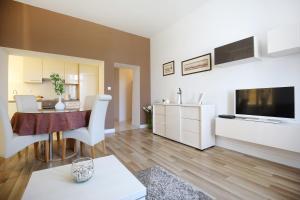 a living room with a kitchen and a dining room at Bay View Apartment in Zadar