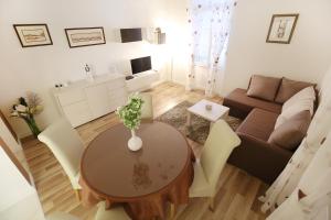 a living room with a table and a couch at Bay View Apartment in Zadar