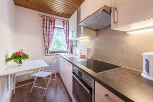a small kitchen with a table and a counter top at Ferienwohnungen Vomperberg in Schwaz